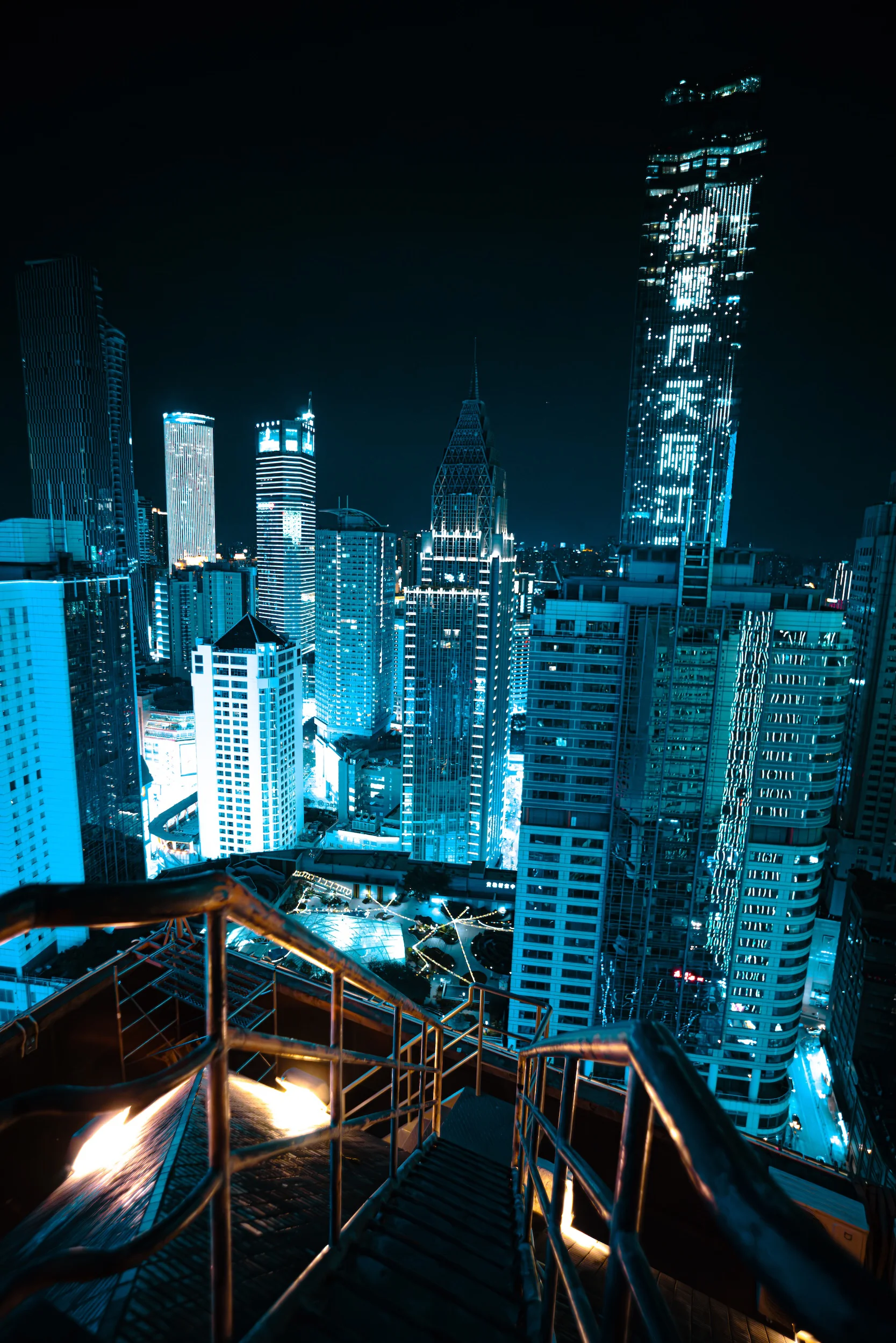 Cyan towers above a rooftop stair
