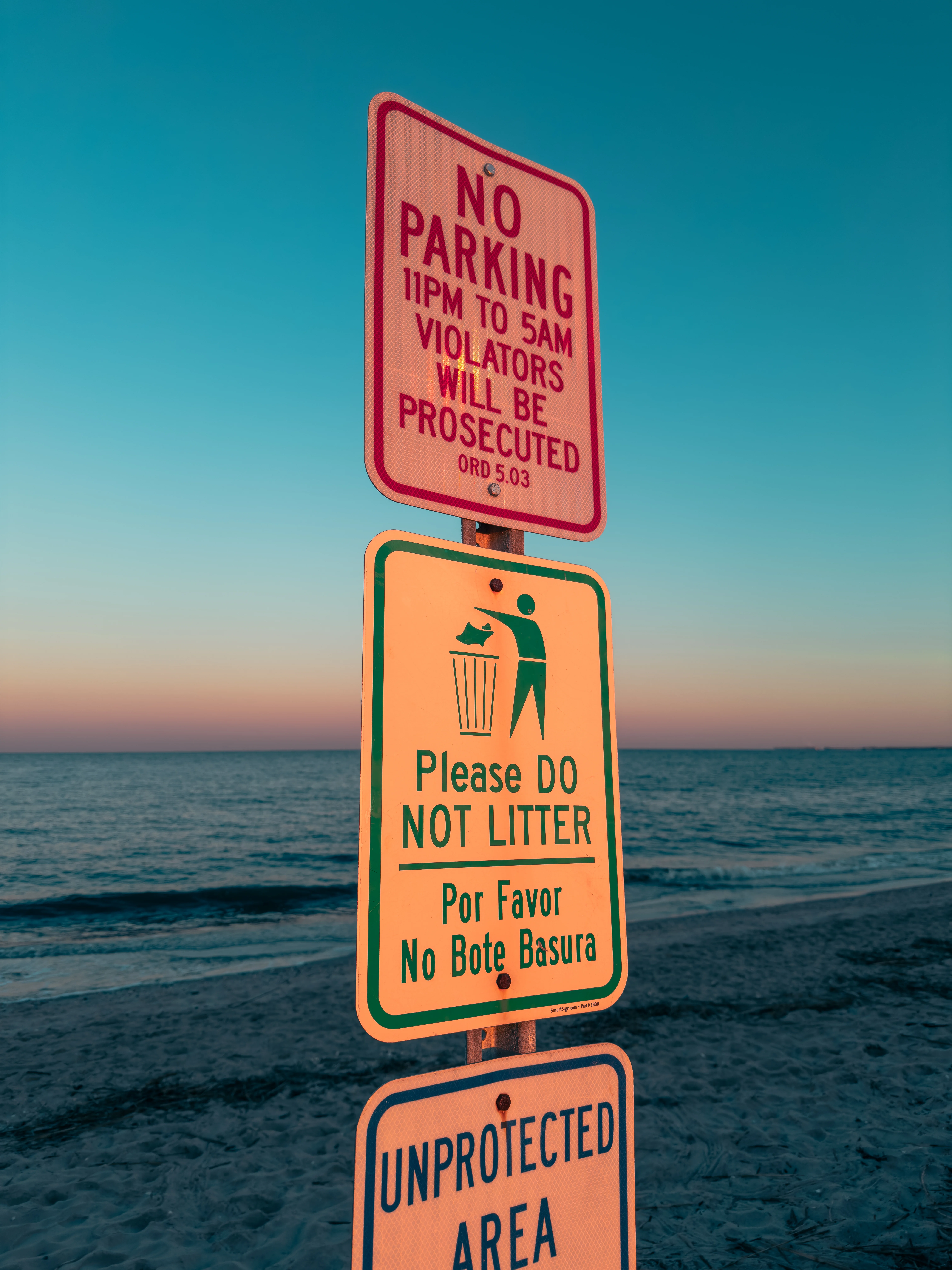 Beach signs glowing at dusk