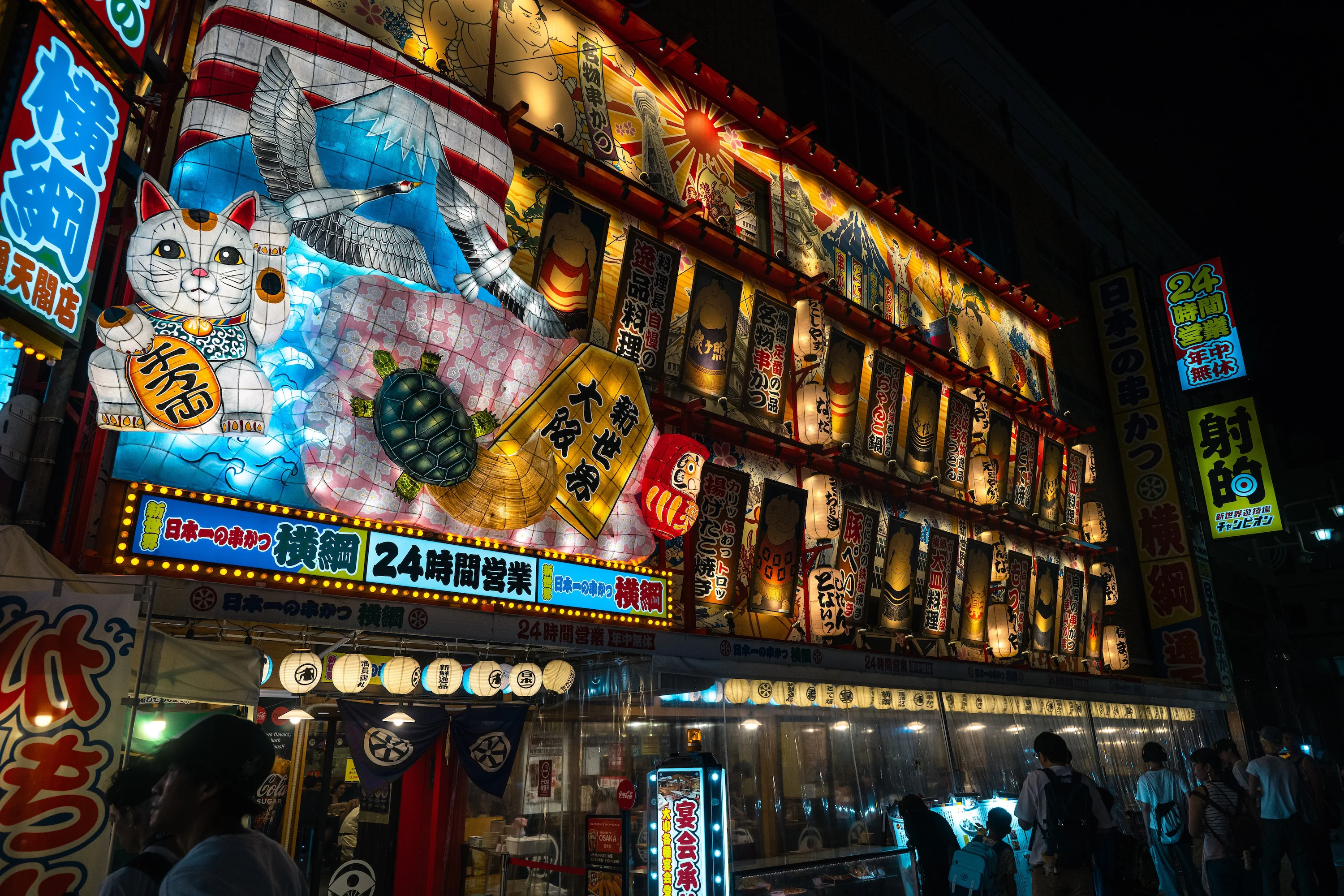 Bright restaurant signs and lanterns in Osaka at night